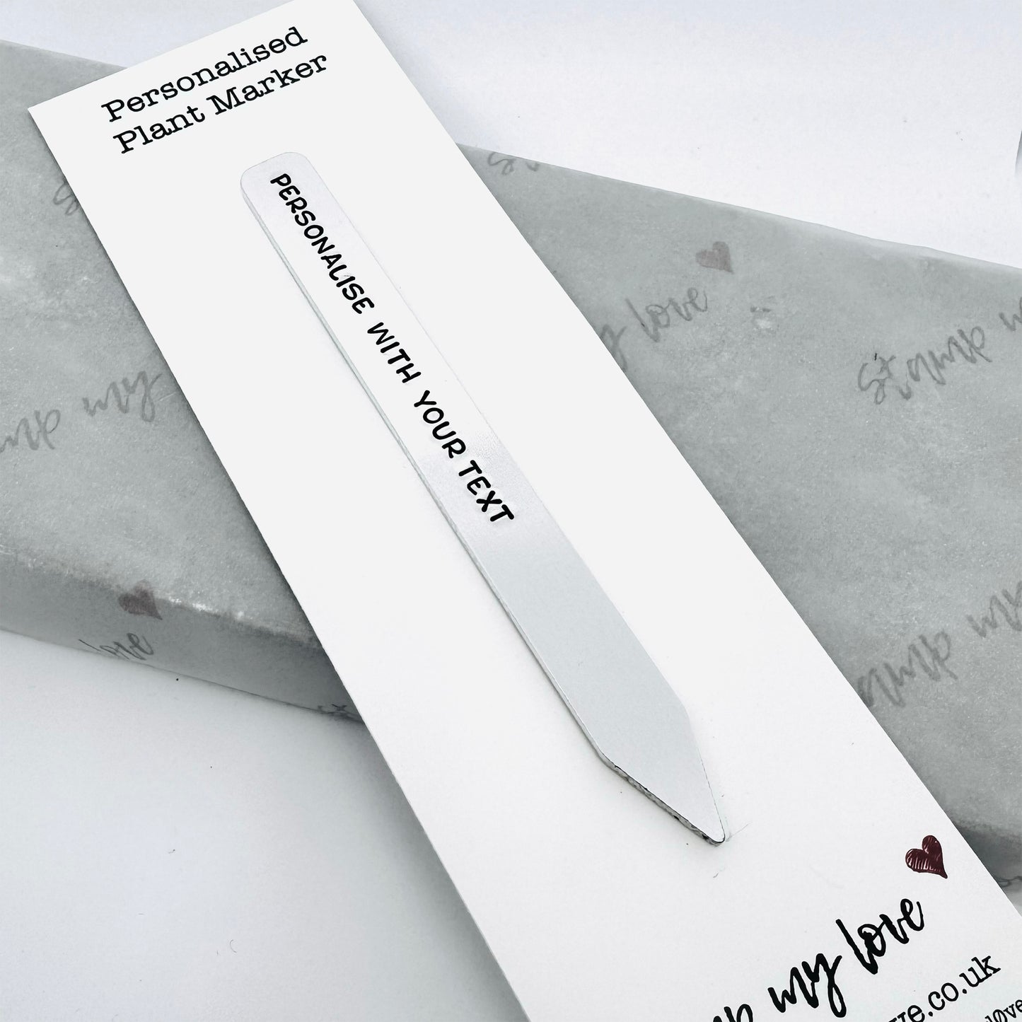 Personalised aluminium plant marker hand-stamped with custom text on backing card