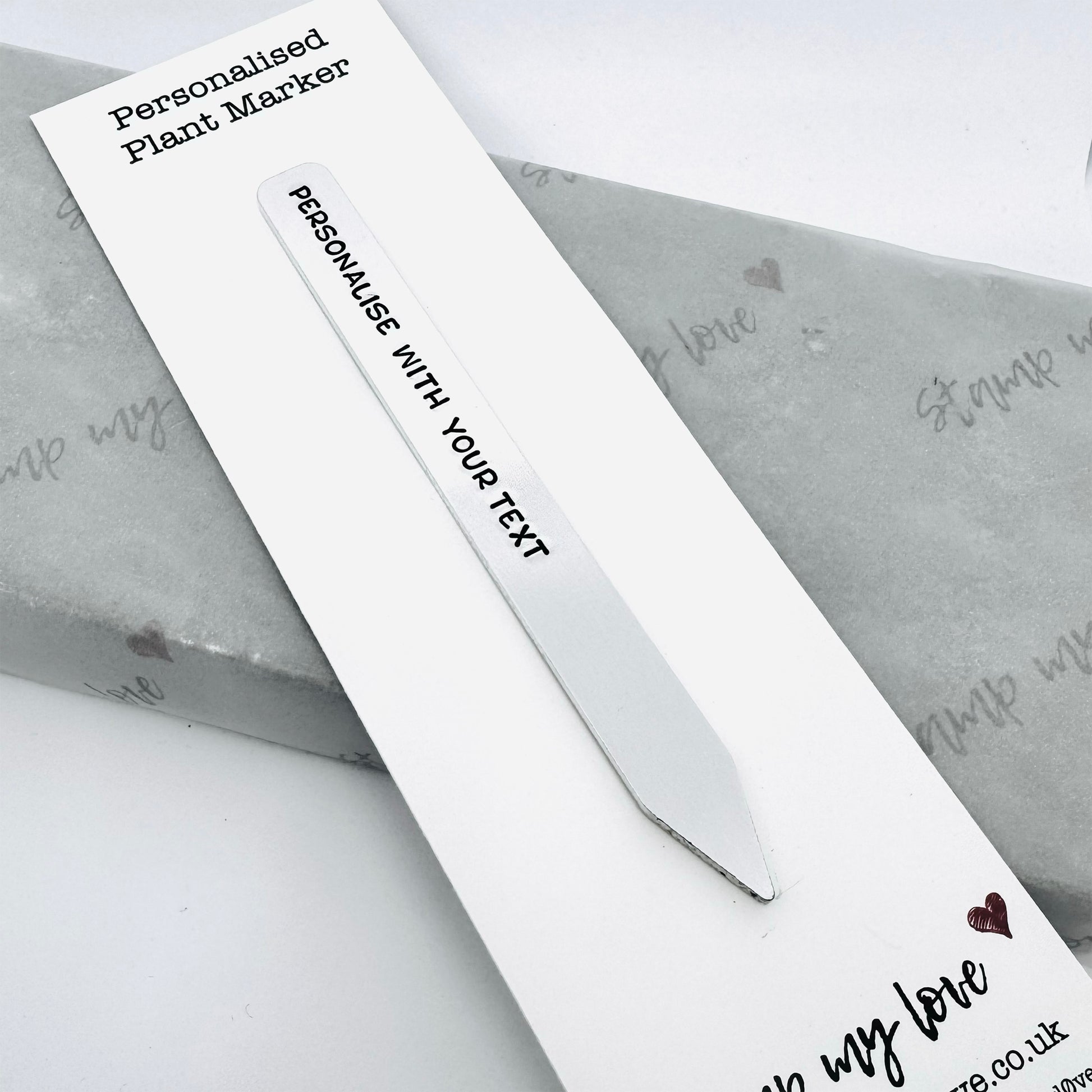 Personalised aluminium plant marker hand-stamped with custom text on backing card