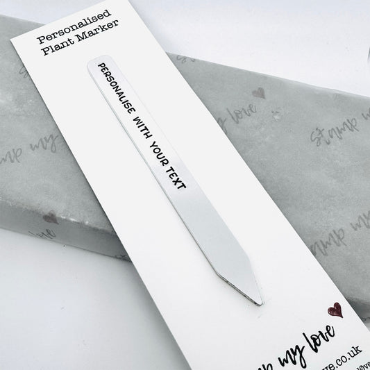 Personalised aluminium plant marker hand-stamped with custom text on backing card